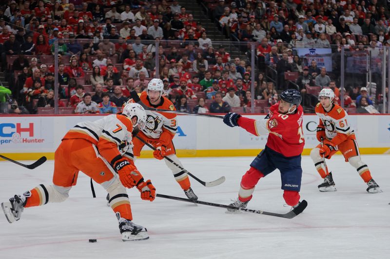 Jan 18, 2025; Sunrise, Florida, USA; Florida Panthers left wing A.J. Greer (10) shoots the puck against the Anaheim Ducks during the first period at Amerant Bank Arena. Mandatory Credit: Sam Navarro-Imagn Images