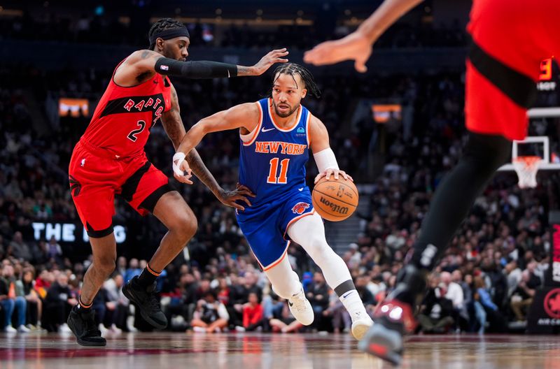 TORONTO, ON - MARCH 27: Jalen Brunson #11 of the New York Knicks drives against Jalen McDaniels #2 of the Toronto Raptors during the first half of their basketball game at the Scotiabank Arena on March 27, 2024 in Toronto, Ontario, Canada. NOTE TO USER: User expressly acknowledges and agrees that, by downloading and/or using this Photograph, user is consenting to the terms and conditions of the Getty Images License Agreement. (Photo by Mark Blinch/Getty Images)