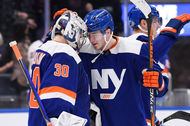 Apr 6, 2023; Elmont, New York, USA; New York Islanders defenseman Noah Dobson (8) celebrates the 6-1 victory against the Tampa Bay Lightning with New York Islanders goaltender Ilya Sorokin (30) after the game at UBS Arena. Mandatory Credit: Dennis Schneidler-USA TODAY Sports