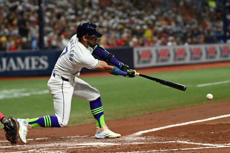 Jul 26, 2024; St. Petersburg, Florida, USA; Tampa Bay Rays second baseman Jose Caballero (7) hits a RBI single in the second inning against the Cincinnati Reds at Tropicana Field. Mandatory Credit: Jonathan Dyer-USA TODAY Sports