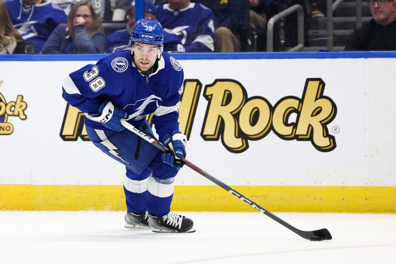 Jan 13, 2024; Tampa, Florida, USA;  Tampa Bay Lightning left wing Brandon Hagel (38) controls the puck against the Anaheim Ducks in the second period at Amalie Arena. Mandatory Credit: Nathan Ray Seebeck-USA TODAY Sports