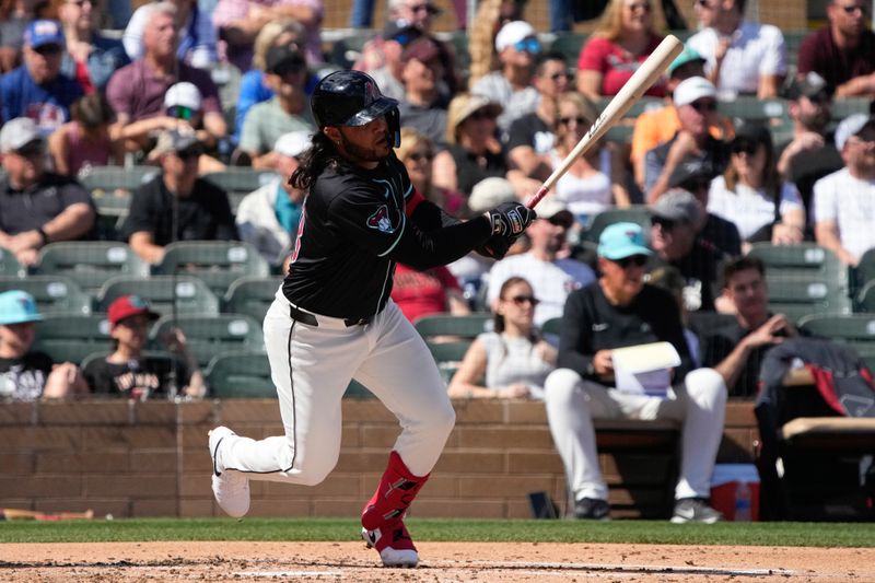 Mar 8, 2024; Salt River Pima-Maricopa, Arizona, USA; Arizona Diamondbacks third baseman Eugenio Suarez (28) hits a single against the Chicago Cubs in the second inning at Salt River Fields at Talking Stick. Mandatory Credit: Rick Scuteri-USA TODAY Sports