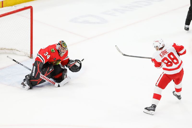 Feb 25, 2024; Chicago, Illinois, USA; Detroit Red Wings right wing Patrick Kane (88) shoots and scores game winning goal against Chicago Blackhawks goaltender Petr Mrazek (34) in overtime at United Center. Mandatory Credit: Kamil Krzaczynski-USA TODAY Sports