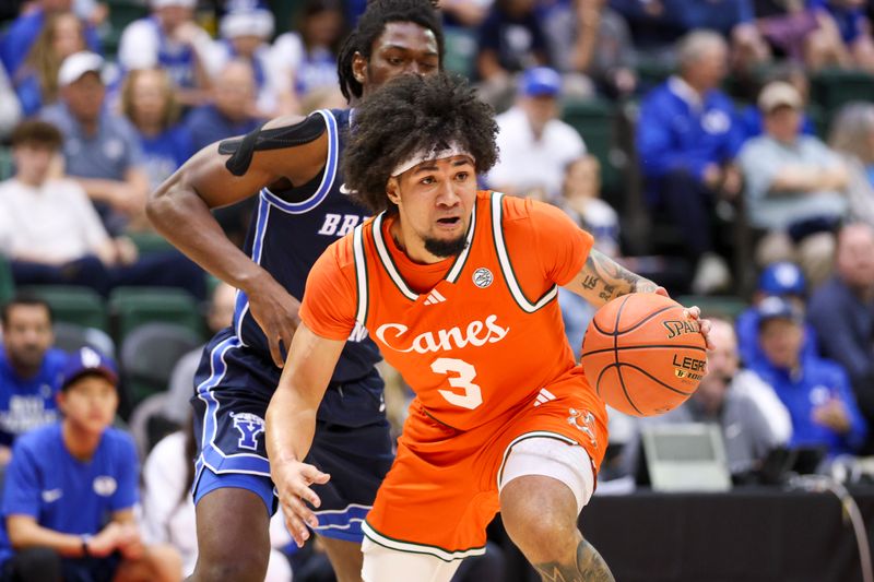 Nov 27, 2025; Kissimmee, Florida, USA; Miami (FL) Hurricanes guard Tre Donaldson (3) controls the ball against the Brigham Young University Cougars in the first half at State Farm Field House. Mandatory Credit: Nathan Ray Seebeck-Imagn Images