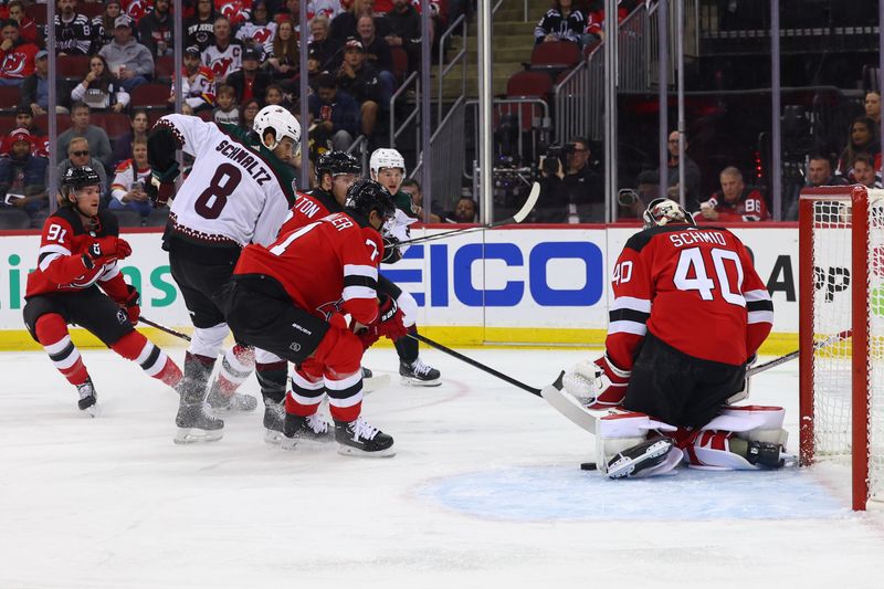 Oct 13, 2023; Newark, New Jersey, USA; New Jersey Devils goaltender Akira Schmid (40) makes a save against the Arizona Coyotes during the first period at Prudential Center. Mandatory Credit: Ed Mulholland-USA TODAY Sports