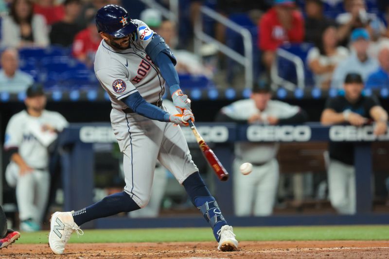 Aug 4, 2025; Miami, Florida, USA; Houston Astros third baseman Carlos Correa (1) hits an RBI single against the Miami Marlins during the fourth inning at loanDepot Park. Mandatory Credit: Sam Navarro-Imagn Images