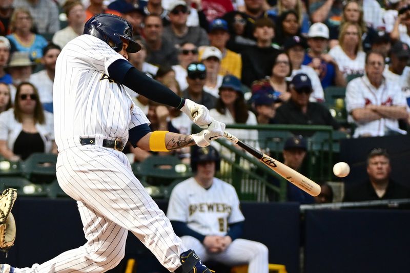 May 27, 2023; Milwaukee, Wisconsin, USA; Milwaukee Brewers catcher Victor Caratini (7) hits a RBI single in the seventh inning against the San Francisco Giants at American Family Field. Mandatory Credit: Benny Sieu-USA TODAY Sports