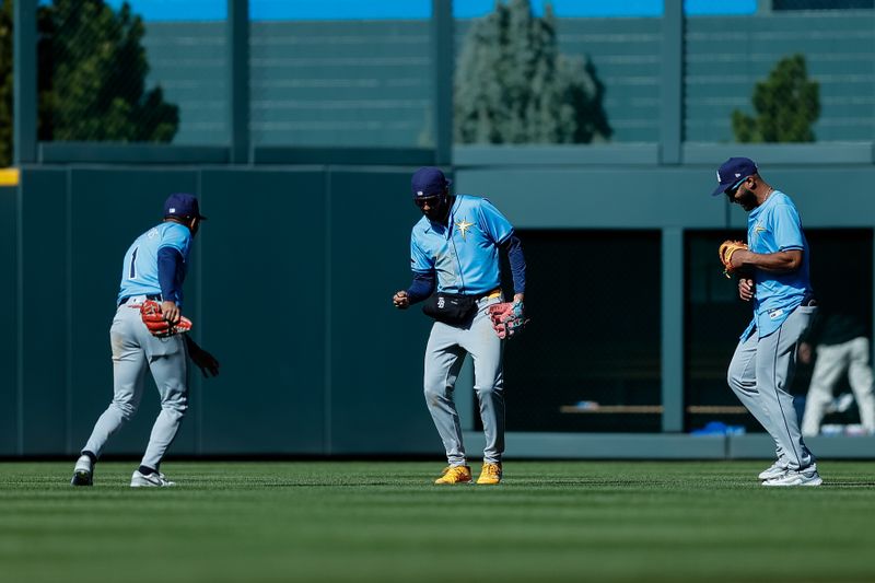 Apr 7, 2024; Denver, Colorado, USA; Tampa Bay Rays left fielder Richie Palacios (1) and center fielder Jose Siri (22) and outfielder Amed Rosario (10) celebrate after the game against the Colorado Rockies at Coors Field. Mandatory Credit: Isaiah J. Downing-USA TODAY Sports