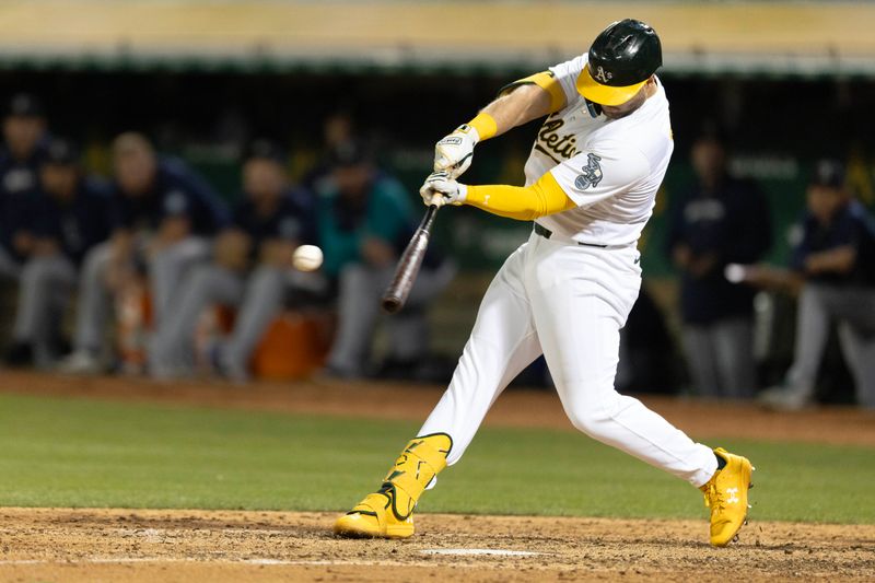 Sep 3, 2024; Oakland, California, USA; Oakland Athletics left fielder Seth Brown (15) hits a game-winning single against the Seattle Mariners during the ninth inning at Oakland-Alameda County Coliseum. Mandatory Credit: D. Ross Cameron-Imagn Images