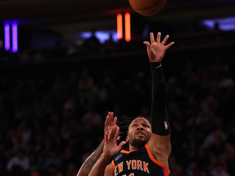 NEW YORK, NEW YORK - FEBRUARY 05:  Jalen Brunson #11 of the New York Knicks takes a shot as P.J. Tucker #17 of the Philadelphia 76ers defends in the second half at Madison Square Garden on February 05, 2023 in New York City. The New York Knicks defeated the Philadelphia 76ers 108-97. NOTE TO USER: User expressly acknowledges and agrees that, by downloading and or using this photograph, User is consenting to the terms and conditions of the Getty Images License Agreement. (Photo by Elsa/Getty Images)