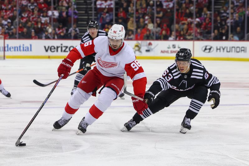 Dec 23, 2023; Newark, New Jersey, USA; Detroit Red Wings defenseman Jake Walman (96) skates with the puck while being defended by New Jersey Devils left wing Jesper Bratt (63) during the first period at Prudential Center. Mandatory Credit: Ed Mulholland-USA TODAY Sports