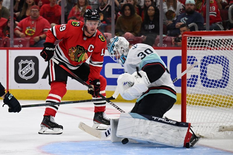 Oct 23, 2022; Chicago, Illinois, USA;  Chicago Blackhawks forward Jonathan Toews (19) attempts to redirect the puck past Seattle Kraken goaltender Martin Jones (30) who makes the save in the second period at United Center. Mandatory Credit: Jamie Sabau-USA TODAY Sports