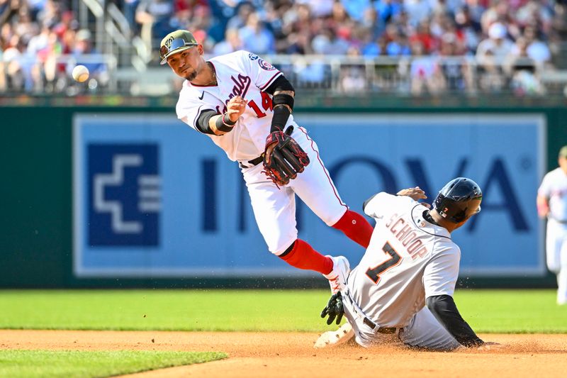 May 20, 2023; Washington, District of Columbia, USA; Washington Nationals second baseman Ildemaro Vargas (14) completes a double play over Detroit Tigers second baseman Jonathan Schoop (7) during the fourth inning at Nationals Park. Mandatory Credit: Brad Mills-USA TODAY Sports