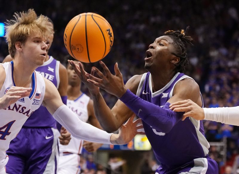 Jan 31, 2023; Lawrence, Kansas, USA; Kansas State Wildcats guard Cam Carter (5) loses control of the ball as Kansas Jayhawks guard Gradey Dick (4) defends during the first half at Allen Fieldhouse. Mandatory Credit: Jay Biggerstaff-USA TODAY Sports