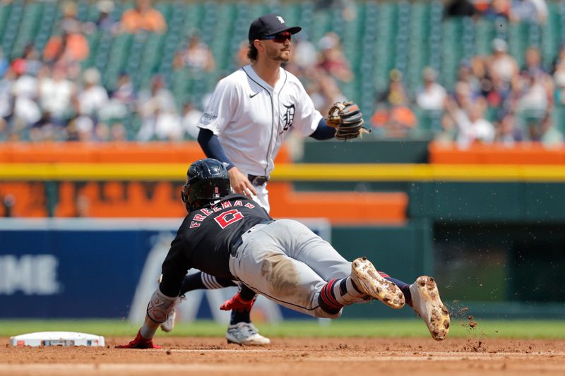 Jul 30, 2024; Detroit, Michigan, USA;  Cleveland Guardians center fielder Tyler Freeman (2) dives into second base after hitting a double against the Detroit Tigers in the seventh inning at Comerica Park. Mandatory Credit: Rick Osentoski-USA TODAY Sports