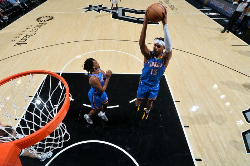 SAN ANTONIO, TX - OCTOBER 7: Ousmane Dieng #13 of the Oklahoma City Thunder goes up for the rebound during the game against the San Antonio Spurs during a NBA preseason game on October 7, 2024 at the Frost Bank Center in San Antonio, Texas. NOTE TO USER: User expressly acknowledges and agrees that, by downloading and or using this photograph, user is consenting to the terms and conditions of the Getty Images License Agreement. Mandatory Copyright Notice: Copyright 2024 NBAE (Photos by Michael Gonzales/NBAE via Getty Images)