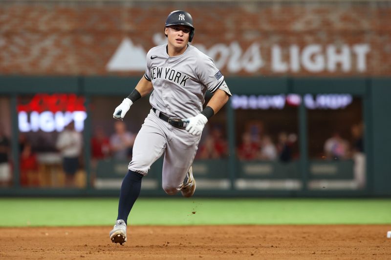 Aug 14, 2023; Atlanta, Georgia, USA; New York Yankees shortstop Anthony Volpe (11) hits a RBI triple against the Atlanta Braves in the ninth inning at Truist Park. Mandatory Credit: Brett Davis-USA TODAY Sports