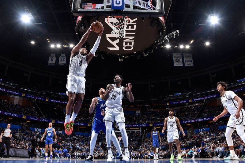 ORLANDO, FL - MARCH 13: Dennis Smith Jr. #4 of the Brooklyn Nets rebounds the ball during the game against the Orlando Magic on March 13, 2024 at the Kia Center in Orlando, Florida. NOTE TO USER: User expressly acknowledges and agrees that, by downloading and or using this photograph, User is consenting to the terms and conditions of the Getty Images License Agreement. Mandatory Copyright Notice: Copyright 2024 NBAE (Photo by Fernando Medina/NBAE via Getty Images)