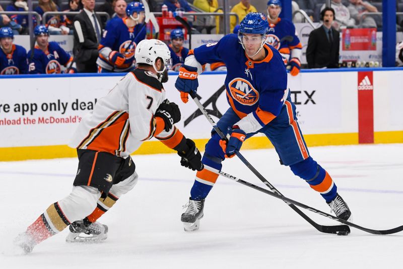 Dec 13, 2023; Elmont, New York, USA; New York Islanders left wing Pierre Engvall (18) attempts a pass defended by Anaheim Ducks defenseman Radko Gudas (7) during the second period at UBS Arena. Mandatory Credit: Dennis Schneidler-USA TODAY Sports