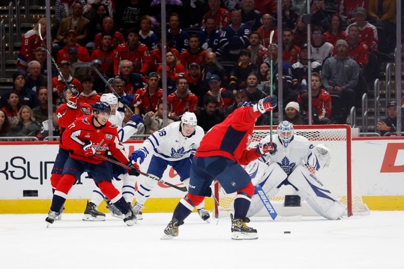 Nov 13, 2024; Washington, District of Columbia, USA; Washington Capitals left wing Alex Ovechkin (8) shoots the puck on Toronto Maple Leafs goaltender Joseph Woll (60) in overtime at Capital One Arena. Mandatory Credit: Geoff Burke-Imagn Images