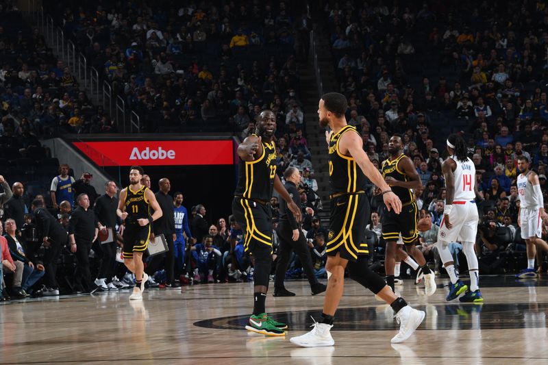 SAN FRANCISCO, CA - FEBRUARY 14: Draymond Green #23 high fives Stephen Curry #30 of the Golden State Warriors during the game against the LA Clippers on FEBRUARY 14, 2024 at Chase Center in San Francisco, California. NOTE TO USER: User expressly acknowledges and agrees that, by downloading and or using this photograph, user is consenting to the terms and conditions of Getty Images License Agreement. Mandatory Copyright Notice: Copyright 2024 NBAE (Photo by Noah Graham/NBAE via Getty Images)