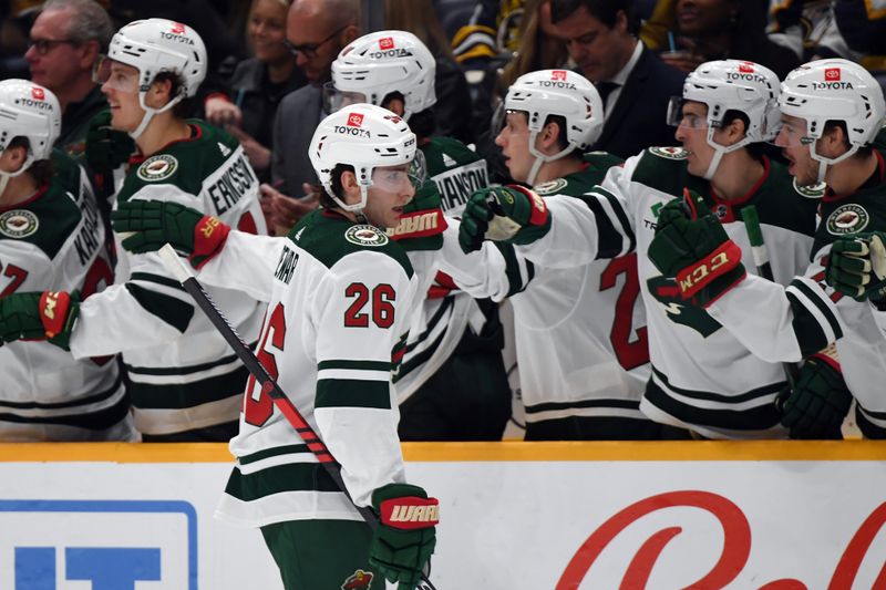 Feb 29, 2024; Nashville, Tennessee, USA; Minnesota Wild center Connor Dewar (26) celebrates with teammates after a goal during the first period against the Nashville Predators at Bridgestone Arena. Mandatory Credit: Christopher Hanewinckel-USA TODAY Sports