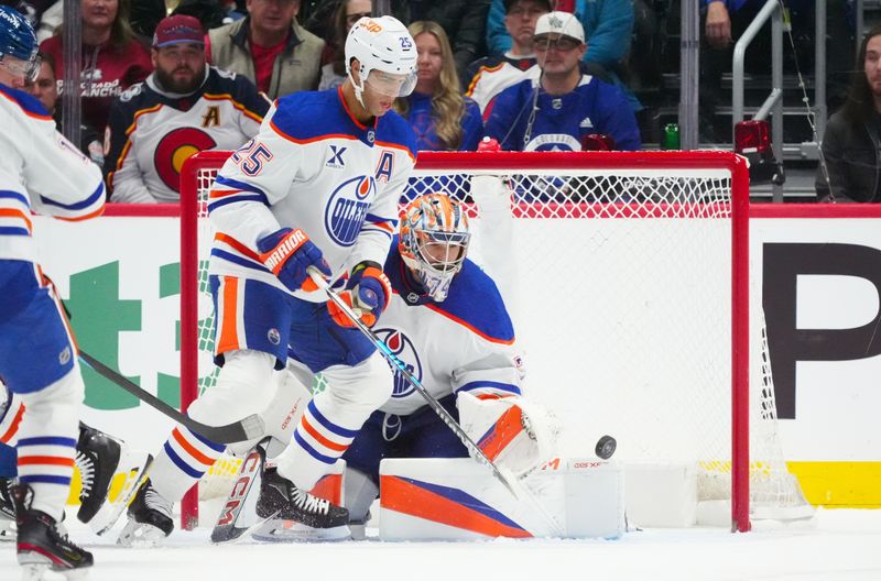 Nov 30, 2024; Denver, Colorado, USA; Edmonton Oilers defenseman Darnell Nurse (25) assists on a save on goaltender Stuart Skinner (74) in the third period against the Colorado Avalanche at Ball Arena. Mandatory Credit: Ron Chenoy-Imagn Images