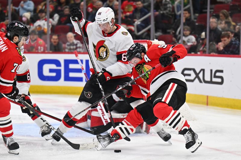 Mar 6, 2023; Chicago, Illinois, USA;  Ottawa Senators defenseman Jake Sanderson (85) and Chicago Blackhawks forward Tyler Johnson (90) battle for control of the puck in the second period at United Center. Mandatory Credit: Jamie Sabau-USA TODAY Sports