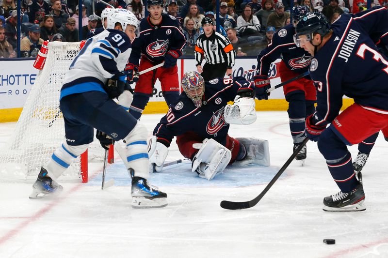 Nov 1, 2024; Columbus, Ohio, USA; Columbus Blue Jackets defenseman Jack Johnson (3) clears a rebound of a  goalie Elvis Merzlikins (90) save against the Winnipeg Jets during the third period at Nationwide Arena. Mandatory Credit: Russell LaBounty-Imagn Images
