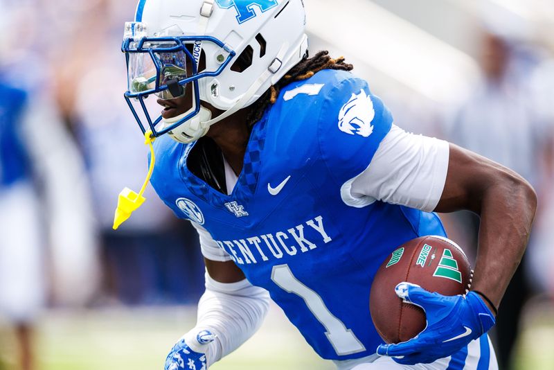 Sep 21, 2024; Lexington, Kentucky, USA; Kentucky Wildcats defensive back Maxwell Hairston (1) intercepts an Ohio Bobcats pass and carries it towards the end zone during the third quarter at Kroger Field. Mandatory Credit: Jordan Prather-Imagn Images