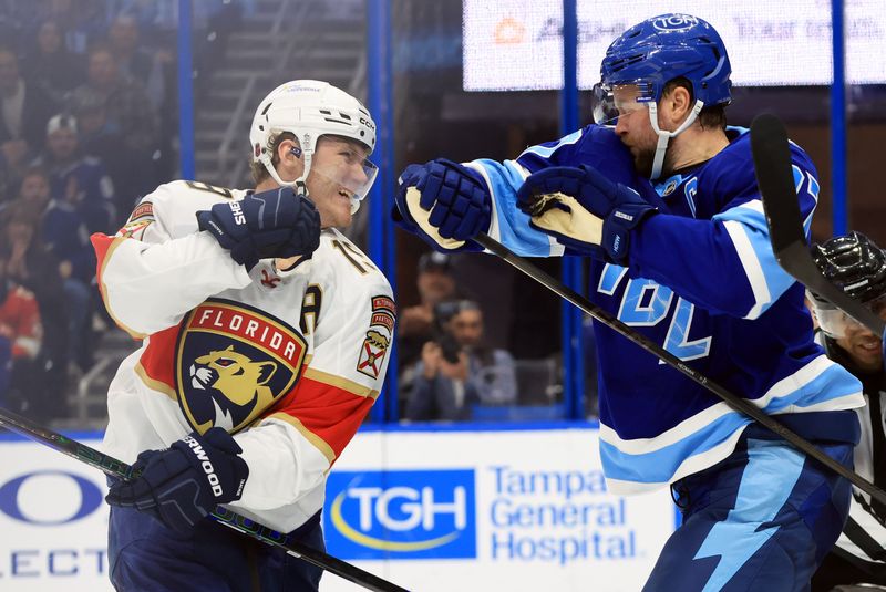 Feb 5, 2026; Tampa, Florida, USA; Florida Panthers left wing Matthew Tkachuk (19) and Tampa Bay Lightning defenseman Victor Hedman (77) fight during the second period at Benchmark International Arena. Mandatory Credit: Kim Klement Neitzel-Imagn Images