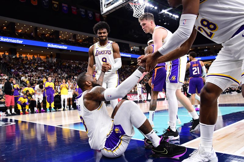 LOS ANGELES, CA - OCTOBER 6: LeBron James #23 helped up by Bronny James #9 and Rui Hachimura #28 of the Los Angeles Lakers during the game against the Phoenix Suns on October 6, 2024 at Acrisure Arena in Palm Springs, California. NOTE TO USER: User expressly acknowledges and agrees that, by downloading and/or using this Photograph, user is consenting to the terms and conditions of the Getty Images License Agreement. Mandatory Copyright Notice: Copyright 2024 NBAE (Photo by Adam Pantozzi/NBAE via Getty Images)