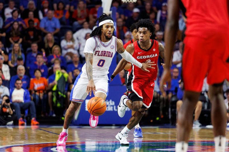 Jan 6, 2026; Gainesville, Florida, USA; Florida Gators guard Boogie Fland (0) dribbles the ball against Georgia Bulldogs guard Marcus Millender (4) during the second half at Exactech Arena at the Stephen C. O'Connell Center. Mandatory Credit: Morgan Tencza-Imagn Images