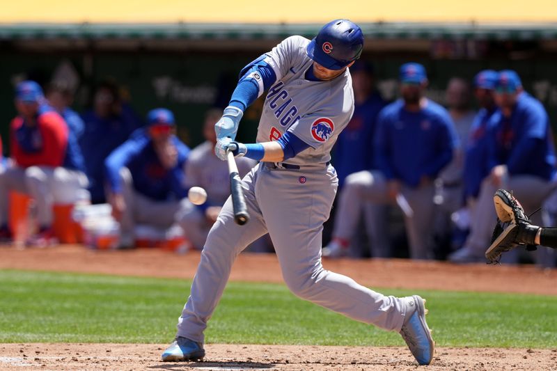 Apr 19, 2023; Oakland, California, USA; Chicago Cubs left fielder Ian Happ (8) hits an RBI double against the Oakland Athletics during the fourth inning at Oakland-Alameda County Coliseum. Mandatory Credit: Darren Yamashita-USA TODAY Sports