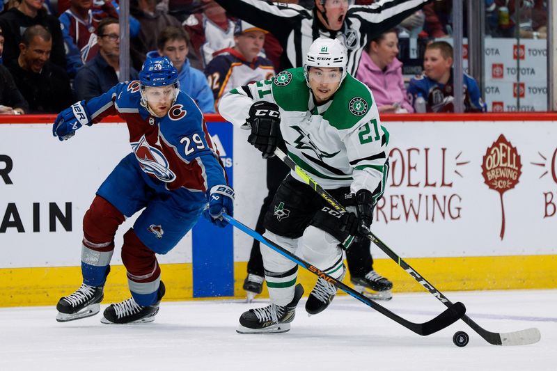 May 11, 2024; Denver, Colorado, USA; Colorado Avalanche center Nathan MacKinnon (29) and Dallas Stars left wing Jason Robertson (21) battle for the puck in the third period in game three of the second round of the 2024 Stanley Cup Playoffs at Ball Arena. Mandatory Credit: Isaiah J. Downing-USA TODAY Sports