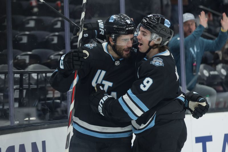 Jan 31, 2025; Salt Lake City, Utah, USA;  Utah Hockey Club center Nick Schmaltz (8) and center Clayton Keller (9) celebrate a Schmaltz goal during the second period against the Columbus Blue Jackets at Delta Center. Mandatory Credit: Chris Nicoll-Imagn Images