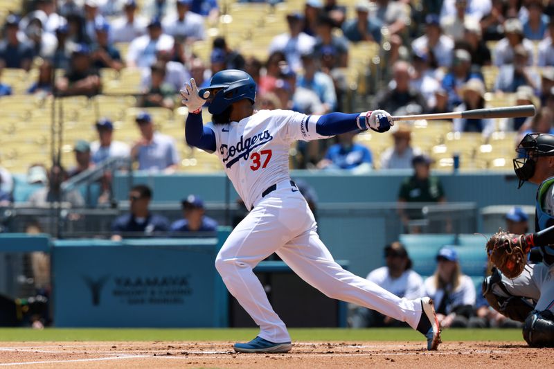 May 8, 2024; Los Angeles, California, USA;  Los Angeles Dodgers outfielder Teoscar Hernandez (37) hits an RBI single during the first inning against the Miami Marlins at Dodger Stadium. Mandatory Credit: Kiyoshi Mio-USA TODAY Sports