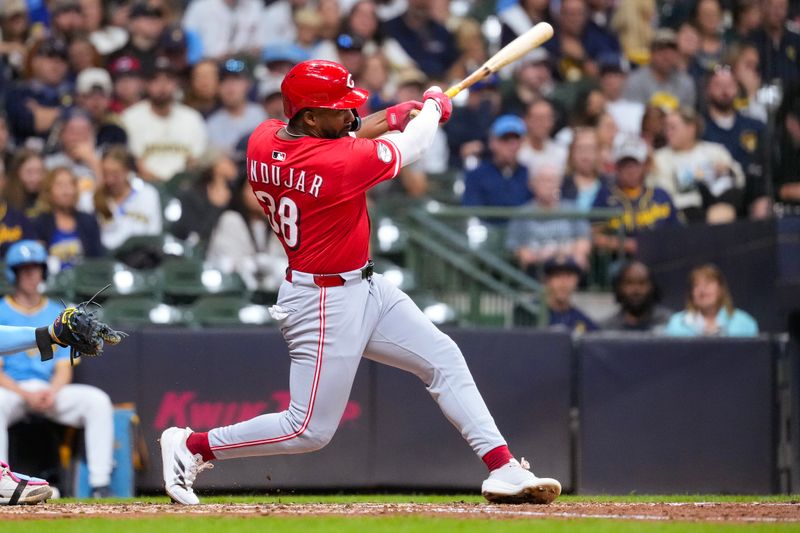 Sep 26, 2025; Milwaukee, Wisconsin, USA;  Cincinnati Reds left fielder Miguel Andujar (38) hits an RBI single during the sixth inning against the Milwaukee Brewers at American Family Field. Mandatory Credit: Jeff Hanisch-Imagn Images