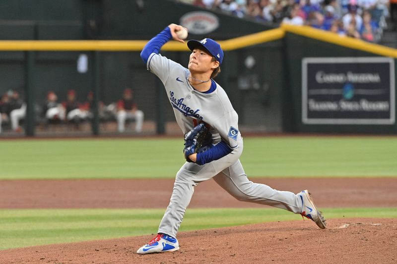 May 8, 2025; Phoenix, Arizona, USA; Los Angeles Dodgers pitcher Yoshinobu Yamamoto (18) throws in the first inning against the Arizona Diamondbacks at Chase Field. Mandatory Credit: Matt Kartozian-Imagn Images