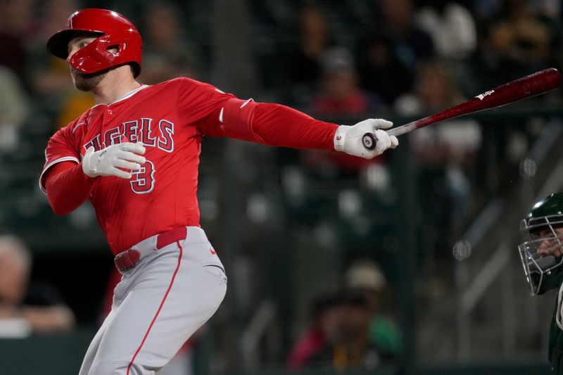 May 21, 2025; West Sacramento, California, USA; Los Angeles Angels left fielder Taylor Ward (3) hits a RBI single against the Athletics in the ninth inning at Sutter Health Park. Mandatory Credit: Cary Edmondson-Imagn Images
