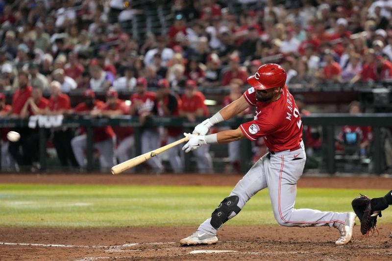 Aug 26, 2023; Phoenix, Arizona, USA; Cincinnati Reds designated hitter Nick Martini (23) hits an RBI single against the Arizona Diamondbacks during the eighth inning at Chase Field. Mandatory Credit: Joe Camporeale-USA TODAY Sports