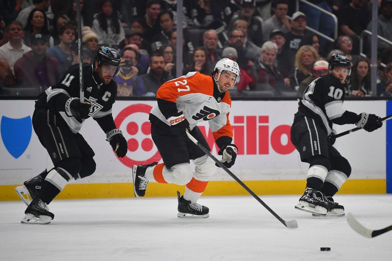 Mar 19, 2026; Los Angeles, California, USA; Philadelphia Flyers left wing Noah Cates (27) plays for the puck against Los Angeles Kings center Anze Kopitar (11) during the first period at Crypto.com Arena. Mandatory Credit: Gary A. Vasquez-Imagn Images