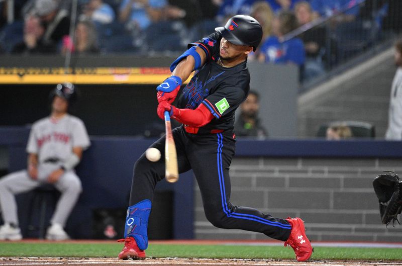 Sep 25, 2024; Toronto, Ontario, CAN;  Toronto Blue Jays center fielder Jonatan Clase (8) hits a single against the Boston Red Sox in the first inning at Rogers Centre. Mandatory Credit: Dan Hamilton-Imagn Images