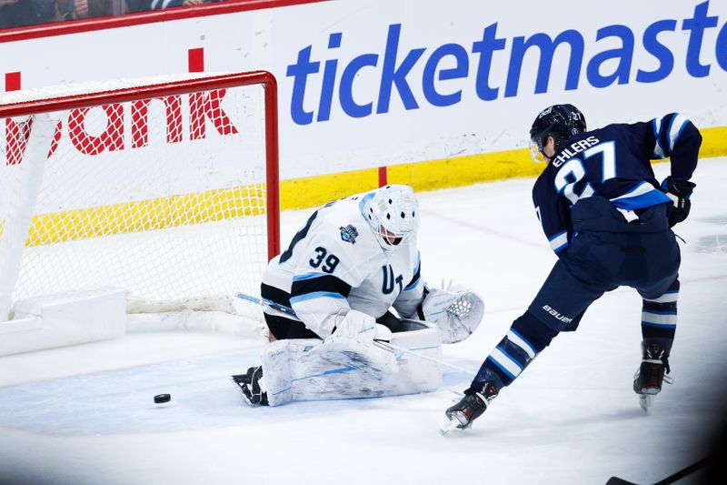 Jan 24, 2025; Winnipeg, Manitoba, CAN; Winnipeg Jets forward Nikolaj Ehlers (27) scores on Utah Hockey Club goalie Connor Ingram (39) during the third period at Canada Life Centre. Mandatory Credit: Terrence Lee-Imagn Images