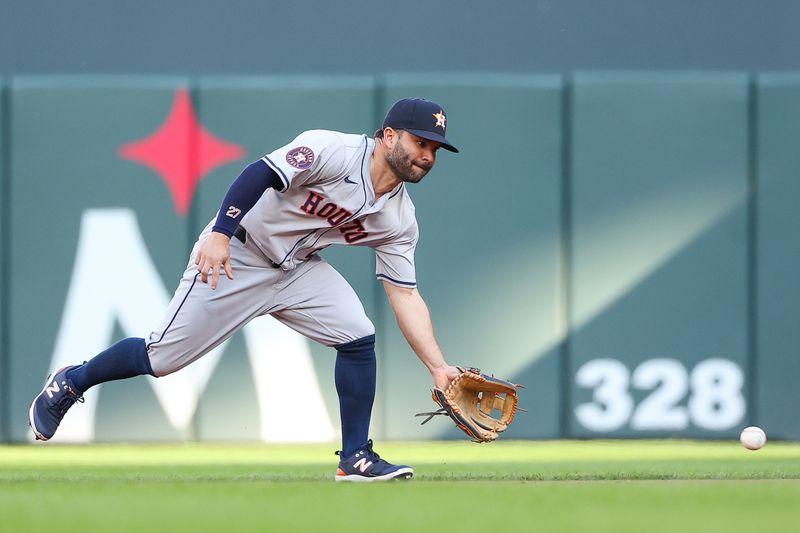 Jul 5, 2024; Minneapolis, Minnesota, USA; Houston Astros second baseman Jose Altuve (27) fields the ball hit by Minnesota Twins second baseman Willi Castro (50) during the first inning at Target Field. Mandatory Credit: Matt Krohn-USA TODAY Sports