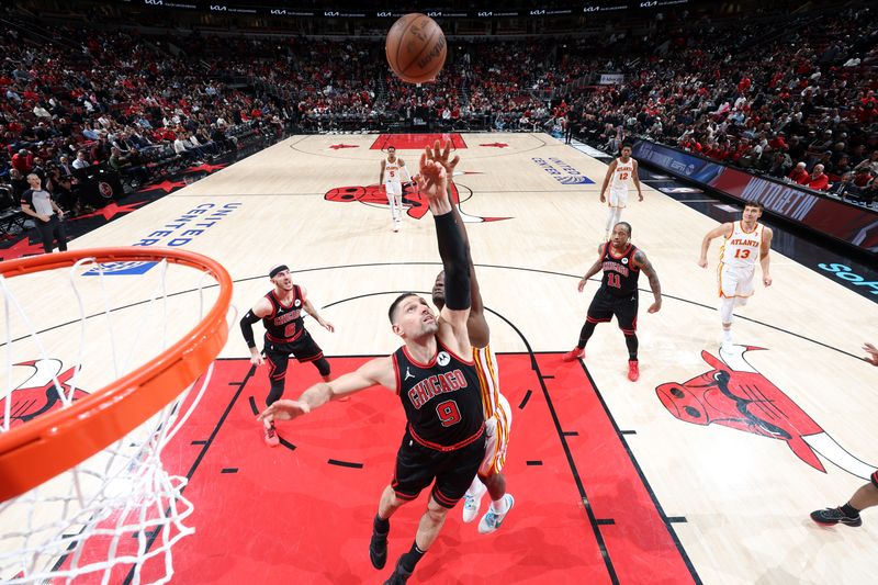 CHICAGO, IL - APRIL 17: Nikola Vucevic #9 of the Chicago Bulls goes up for the rebound during the game against the Atlanta Hawks during the 2024 Play-In Tournament  on April 17, 2024 at United Center in Chicago, Illinois. NOTE TO USER: User expressly acknowledges and agrees that, by downloading and or using this photograph, User is consenting to the terms and conditions of the Getty Images License Agreement. Mandatory Copyright Notice: Copyright 2024 NBAE (Photo by Jeff Haynes/NBAE via Getty Images)