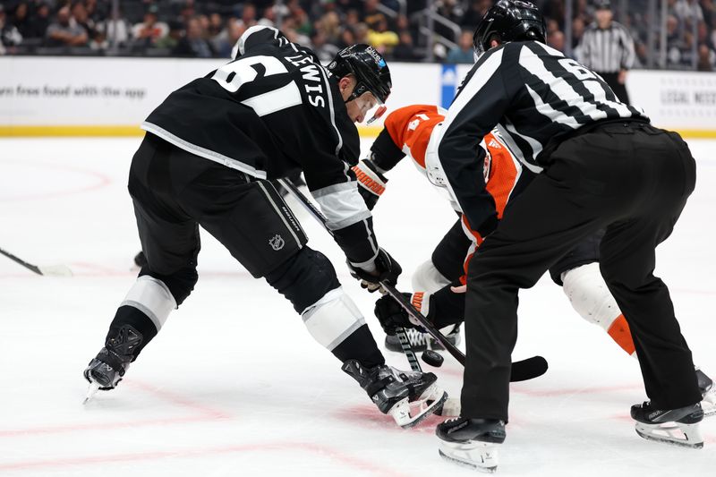 Nov 11, 2023; Los Angeles, California, USA;  Los Angeles Kings center Trevor Lewis (61) and Philadelphia Flyers center Sean Couturier (14) battles for the puck at a face off during the third period at Crypto.com Arena. Mandatory Credit: Kiyoshi Mio-USA TODAY Sports