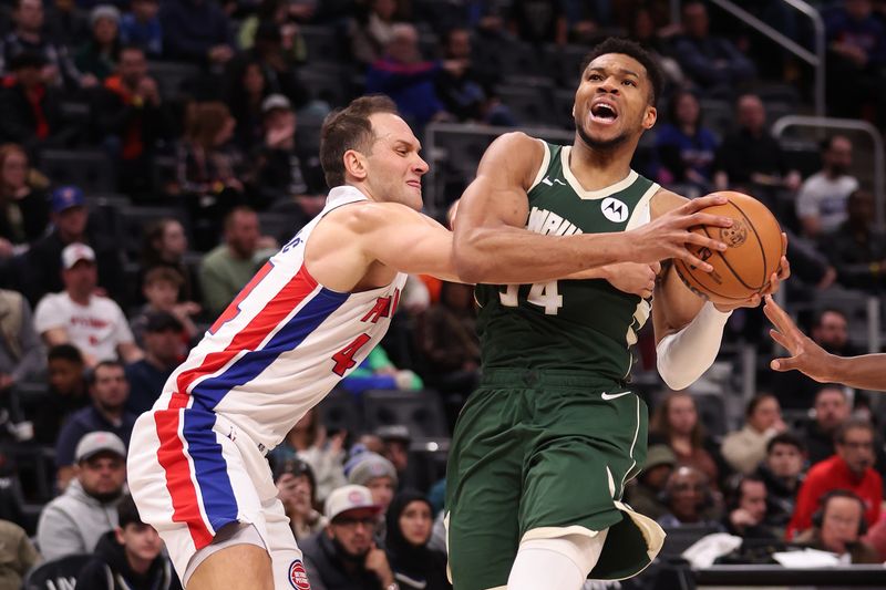 DETROIT, MICHIGAN - JANUARY 22: Giannis Antetokounmpo #34 of the Milwaukee Bucks drives to the basket against Bojan Bogdanovic #44 of the Detroit Pistons during the first half at Little Caesars Arena on January 22, 2024 in Detroit, Michigan. NOTE TO USER: User expressly acknowledges and agrees that, by downloading and or using this photograph, User is consenting to the terms and conditions of the Getty Images License  (Photo by Gregory Shamus/Getty Images)