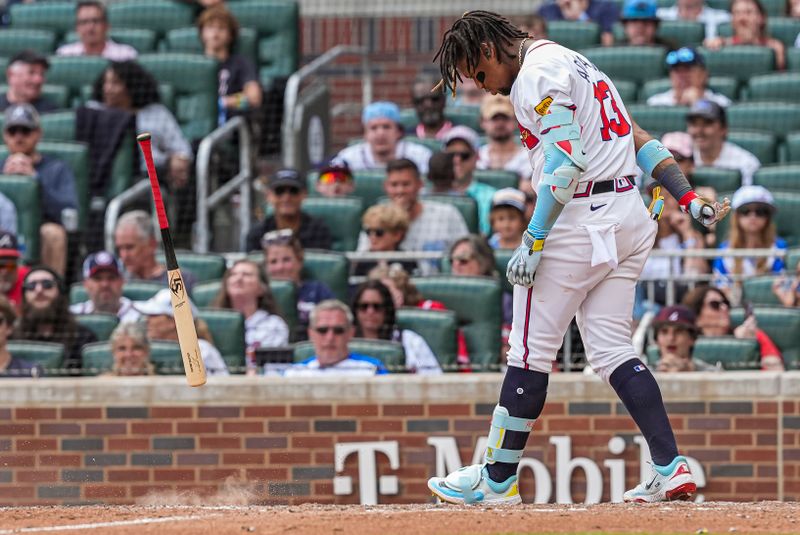 Apr 26, 2024; Cumberland, Georgia, USA; Atlanta Braves right fielder Ronald Acuna Jr (13) reacts by throwing his bat after being called out on strikes against the Cleveland Guardians during the ninth inning at Truist Park. Mandatory Credit: Dale Zanine-USA TODAY Sports