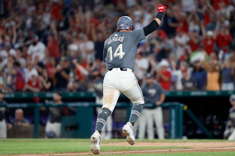 Jul 20, 2024; Washington, District of Columbia, USA; Washington Nationals second base Ildemaro Vargas (14) scores the go ahead run on an RBI single against the Cincinnati Reds during the eighth inning at Nationals Park. Mandatory Credit: Geoff Burke-USA TODAY Sports
